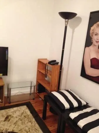 a view of a hallway with furniture and wooden floor