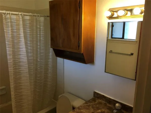 a bedroom with a bed and a night stand