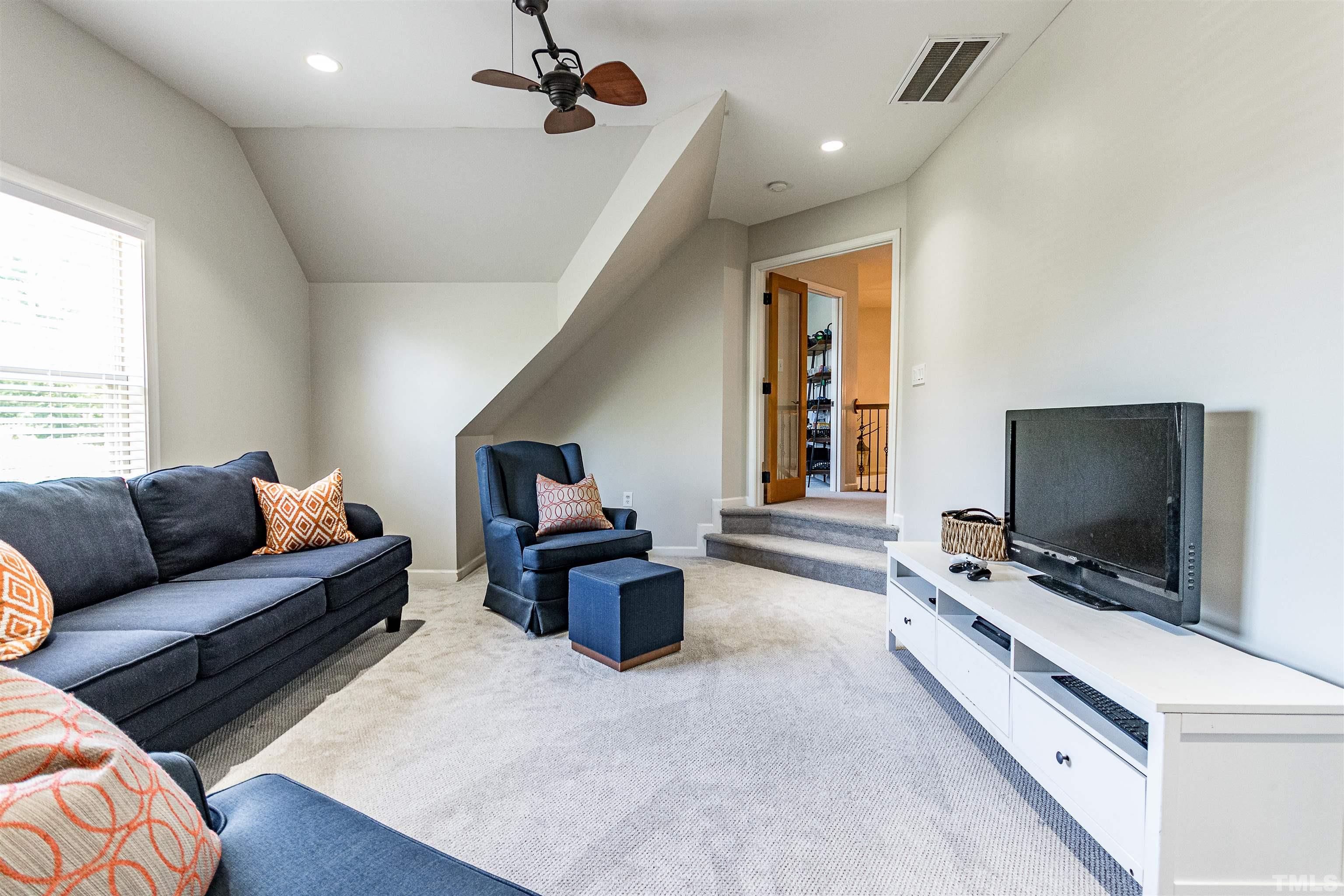 9009 Cornwell Drive Wake Forest, NC 27587 - Photo 23 of 36 a living room with furniture and a flat screen tv