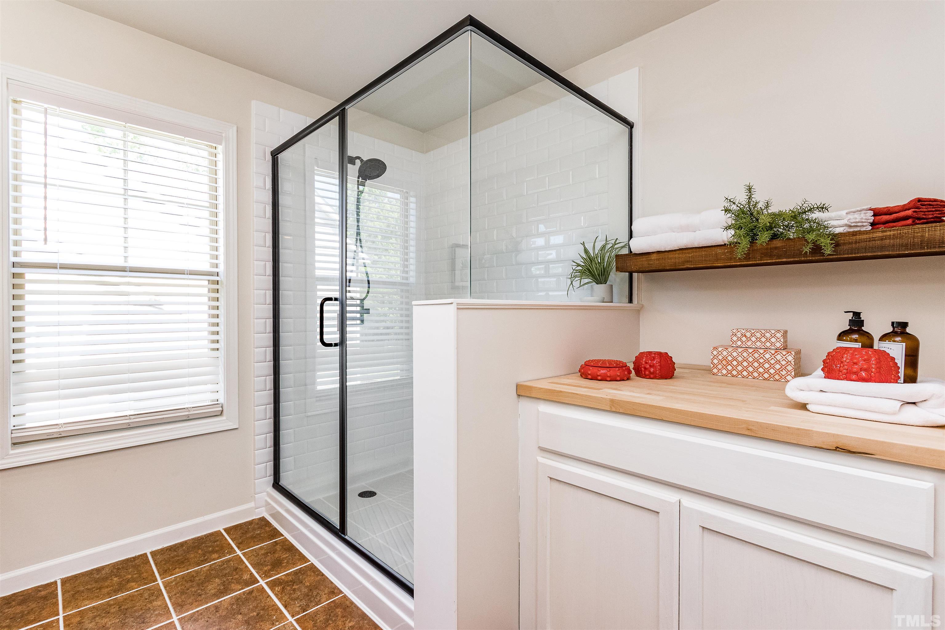 9009 Cornwell Drive Wake Forest, NC 27587 - Photo 28 of 36 a bathroom with a shower and a sink