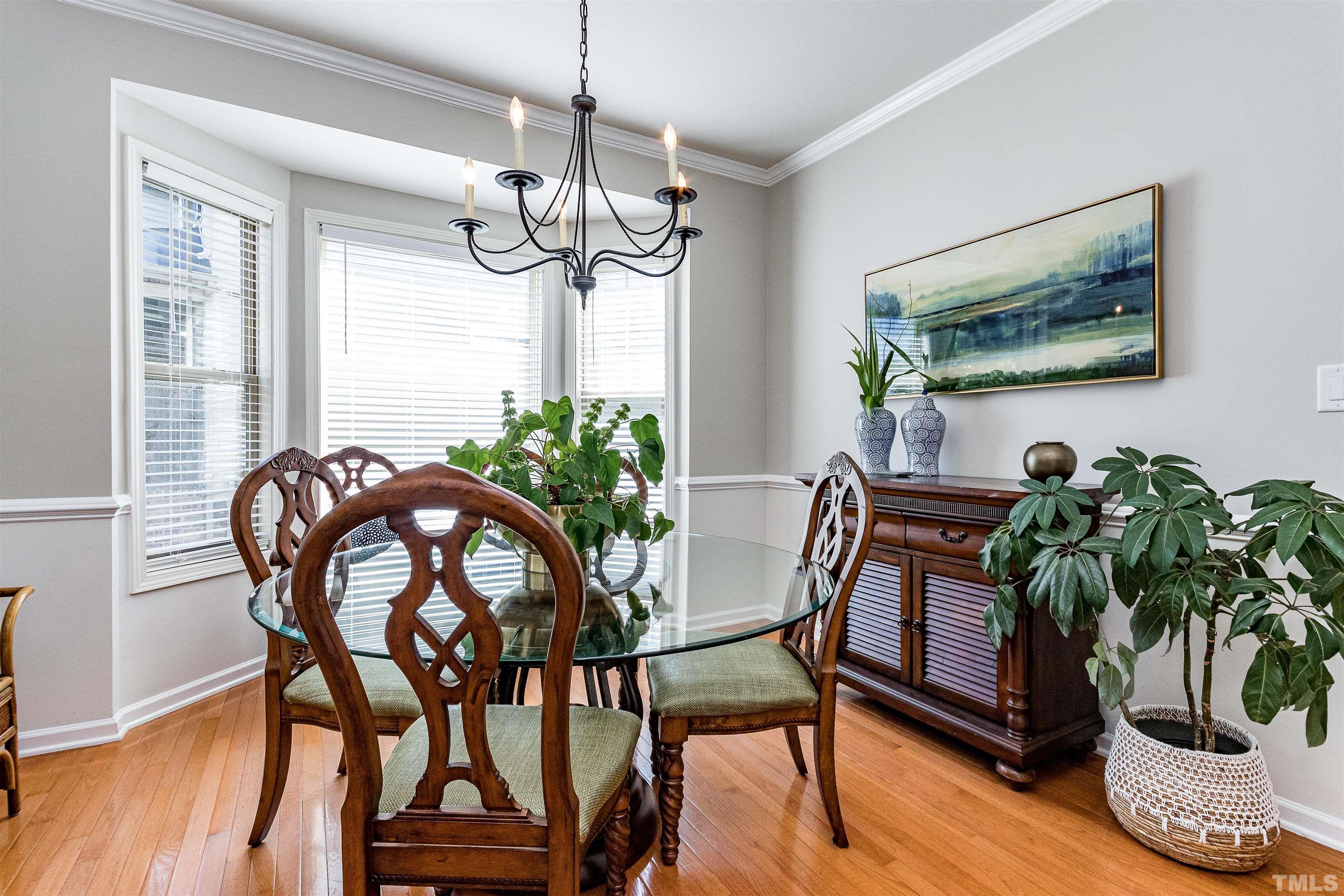 9009 Cornwell Drive Wake Forest, NC 27587 - Photo 7 of 36 a view of a dining room with furniture window and wooden floor