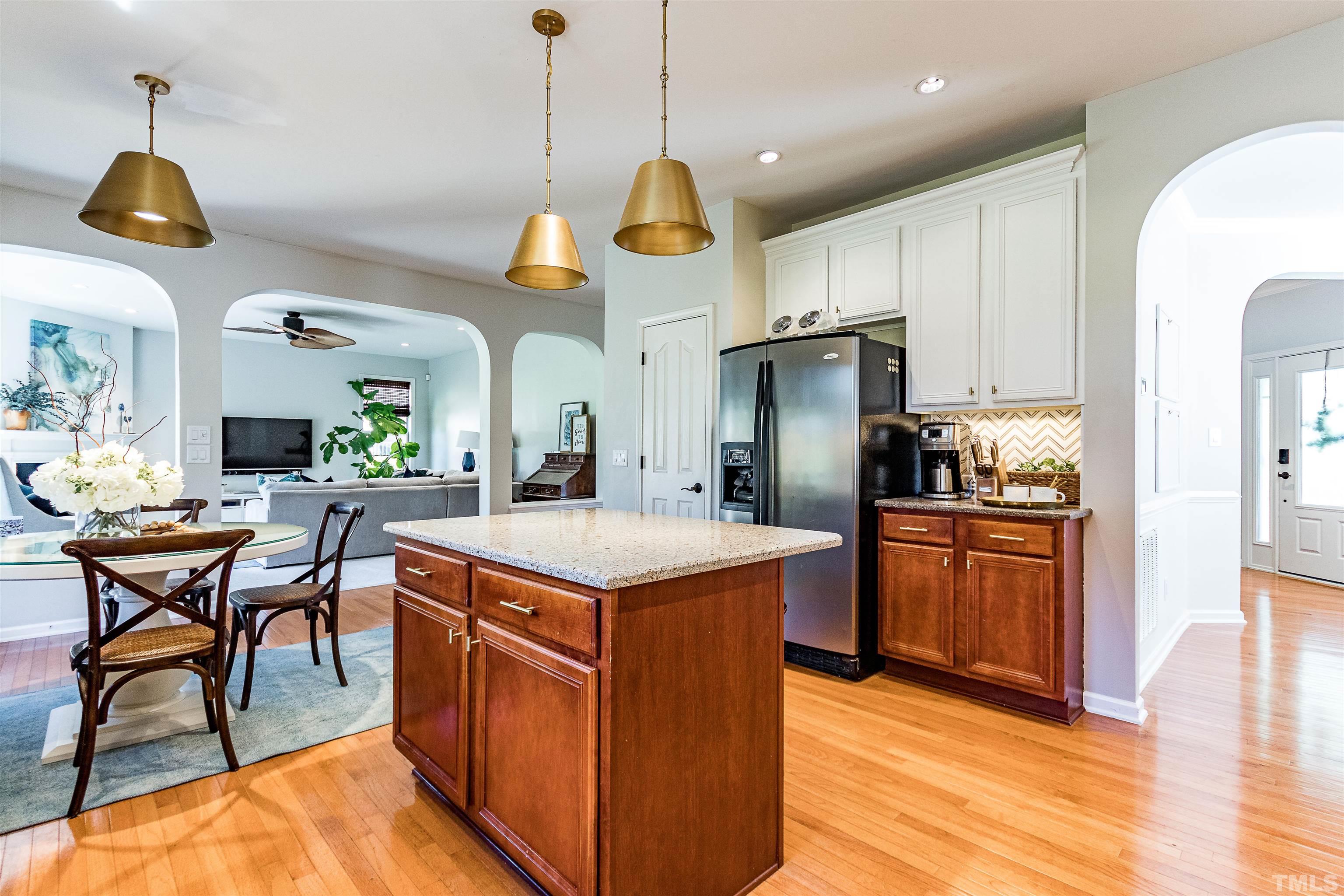 9009 Cornwell Drive Wake Forest, NC 27587 - Photo 10 of 36 a kitchen with stainless steel appliances granite countertop counter space and wooden floors