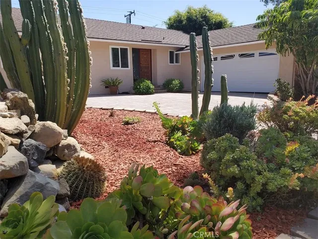 a front view of a house with a yard garage and outdoor seating