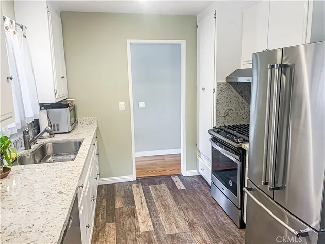a kitchen with a refrigerator stove and sink