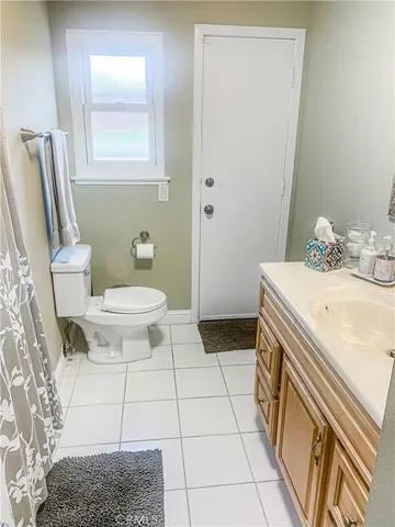 a bathroom with a sink toilet and mirror
