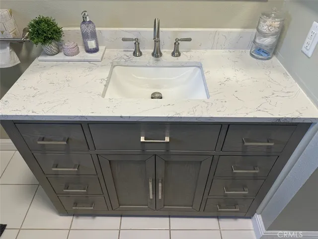 a bathroom with a sink and mirror