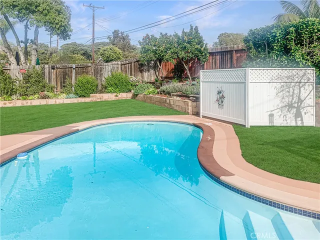 a view of a swimming pool with a yard
