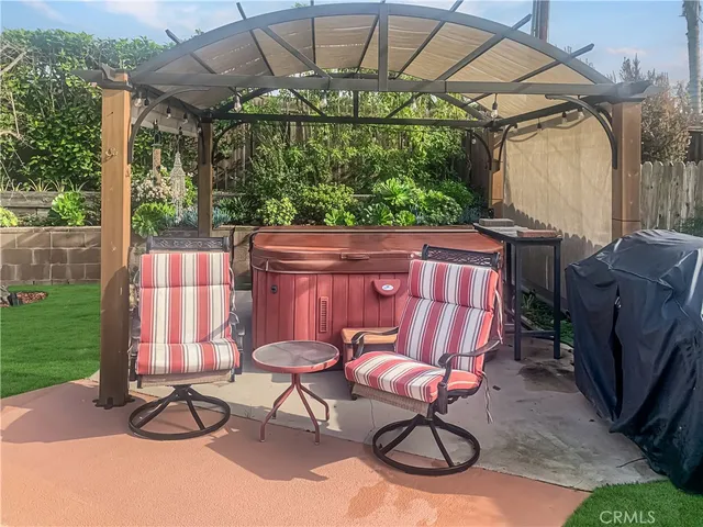 a view of patio with table and chairs under an umbrella