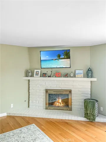 a view of living room with furniture and a fireplace