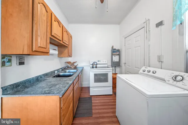 a kitchen that has a sink and a stove in it