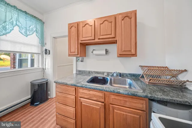 a kitchen with granite countertop a sink and cabinets