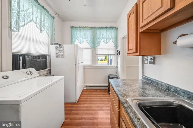 a kitchen that has a sink and a stove in it