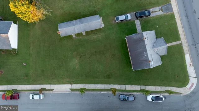 an aerial view of a house with a yard