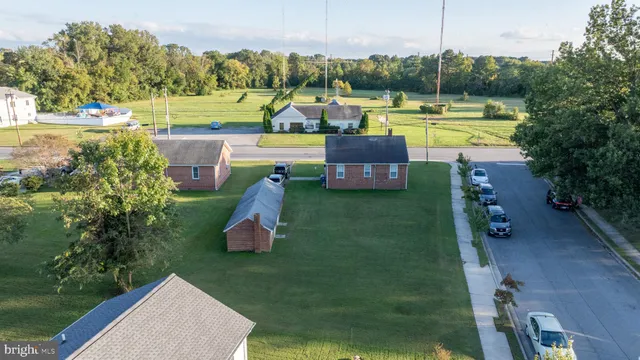 a view of a swimming pool and lounge chairs in back yard
