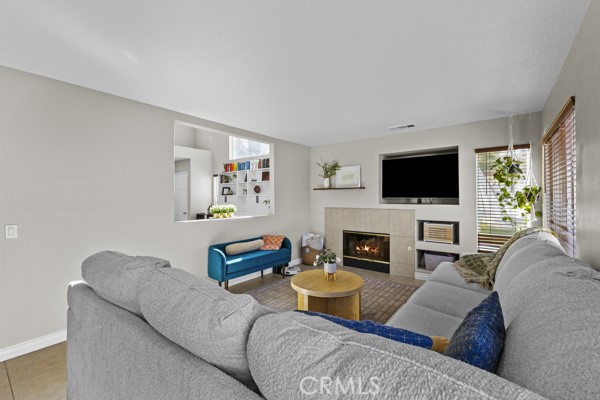 26932 St Julian Circle Murrieta, CA 92563 - Photo 16 of 37 a living room with furniture a fireplace and a flat screen tv