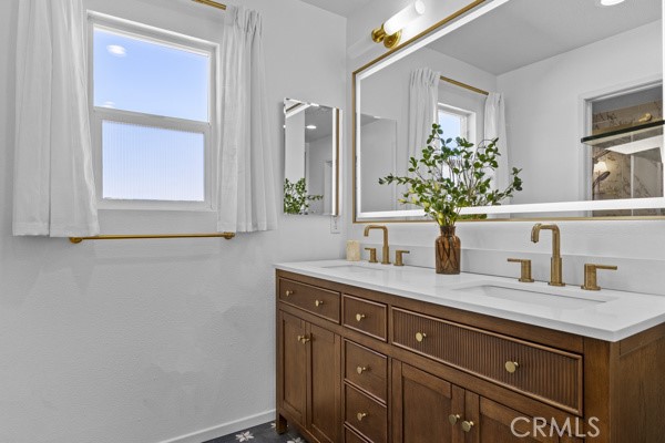 26932 St Julian Circle Murrieta, CA 92563 - Photo 19 of 37 a bathroom with a granite countertop sink and a mirror