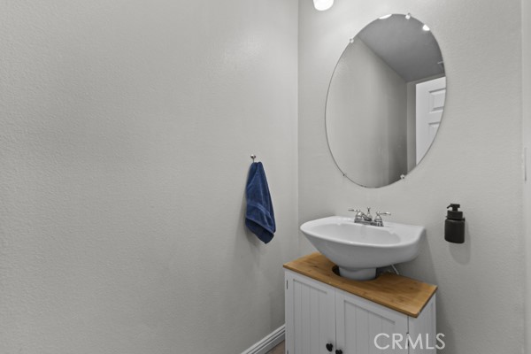 26932 St Julian Circle Murrieta, CA 92563 - Photo 26 of 37 a bathroom with a sink and mirror