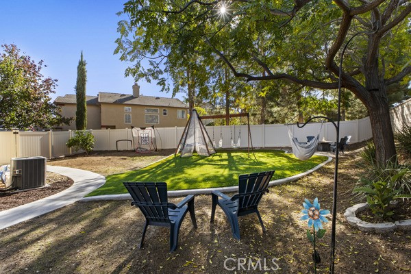26932 St Julian Circle Murrieta, CA 92563 - Photo 30 of 37 a view of a backyard with table and chairs potted plants and a large tree