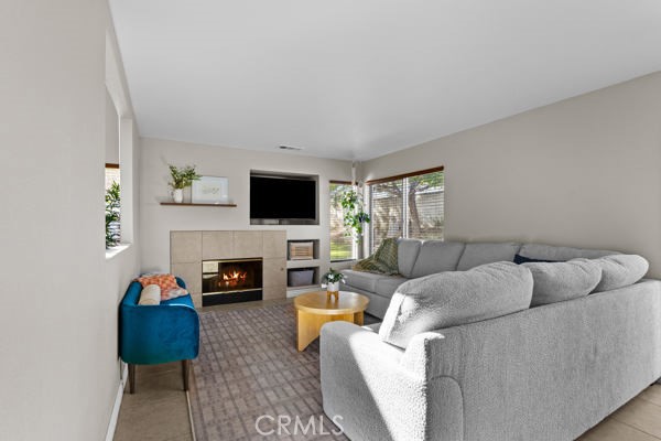 26932 St Julian Circle Murrieta, CA 92563 - Photo 10 of 37 a living room with furniture a fireplace and a flat screen tv