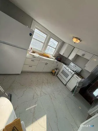 a bathroom with a toilet sink and shower