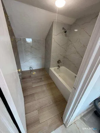 a view of an entryway with wooden floor