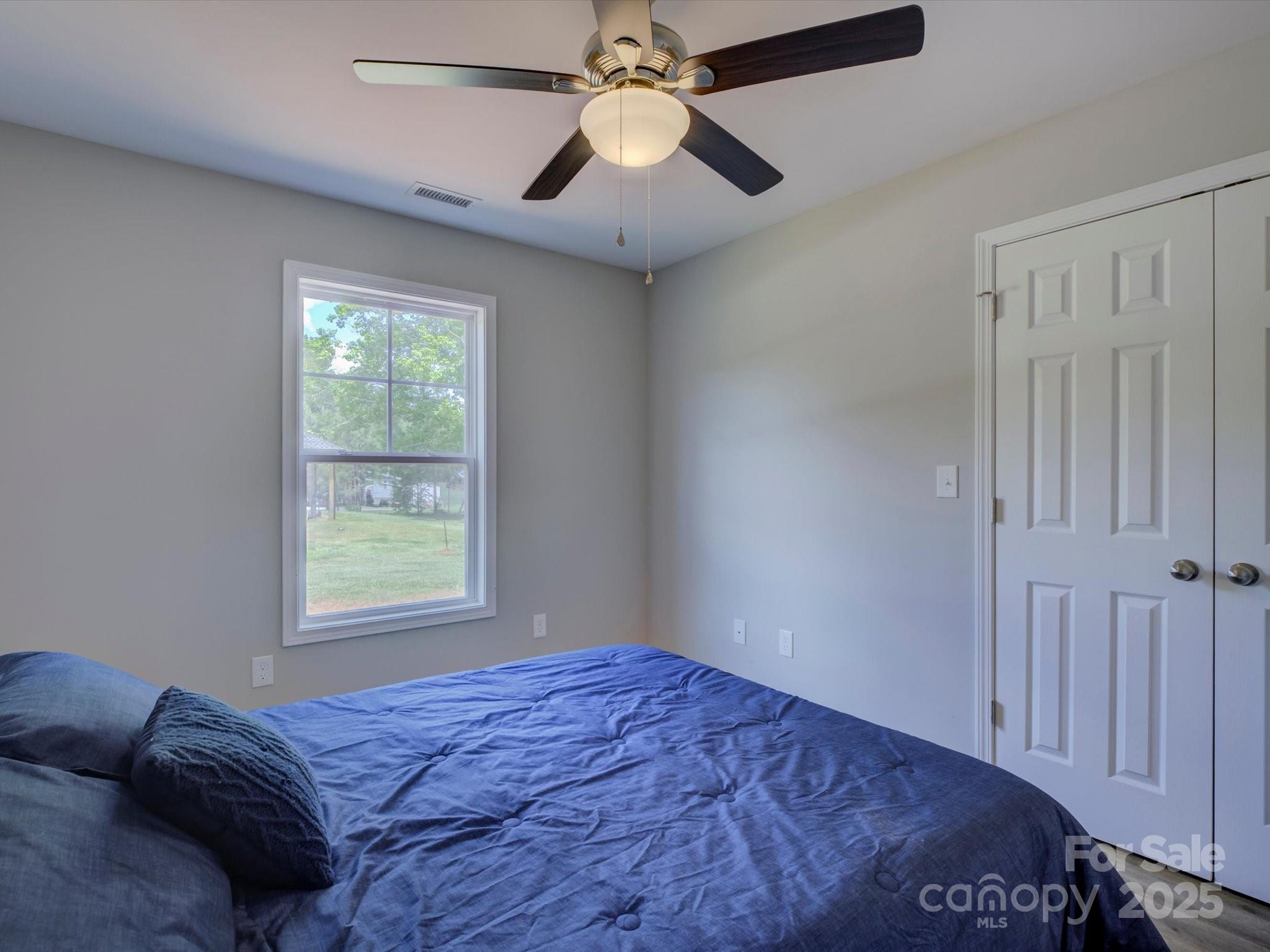 1454 King Road York, SC 29745 - Photo 16 of 34 a bedroom with a bed and a chandelier fan