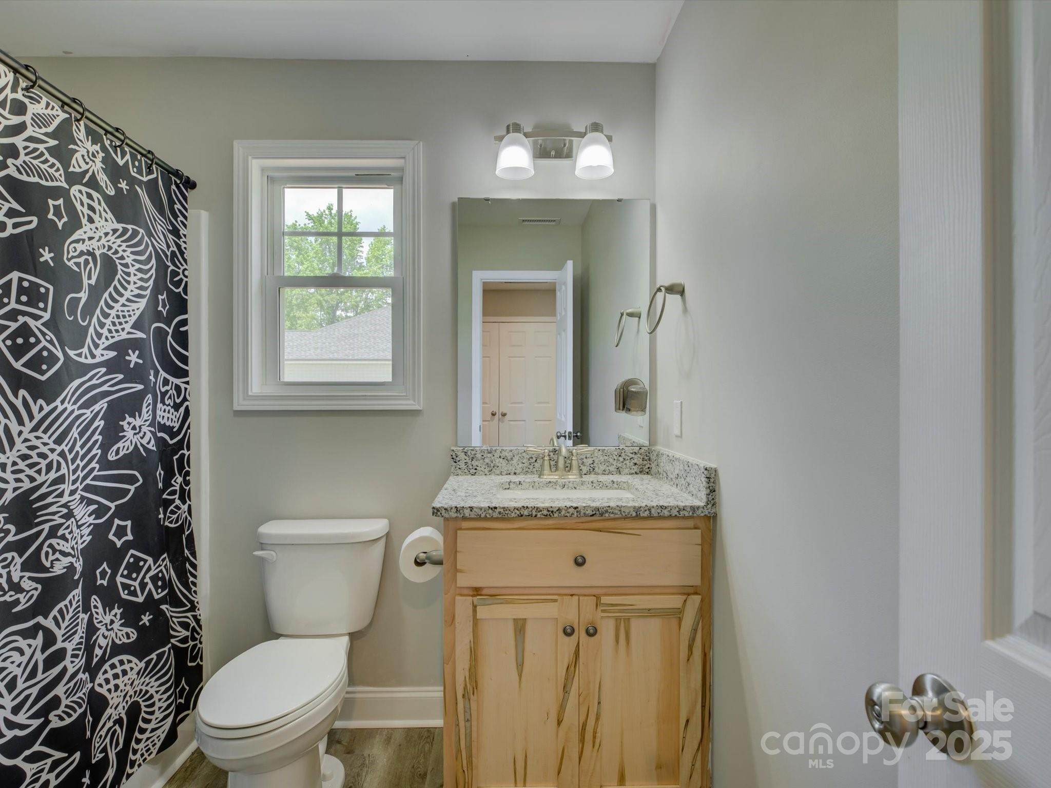 1454 King Road York, SC 29745 - Photo 25 of 34 a bathroom with a granite countertop toilet sink and mirror