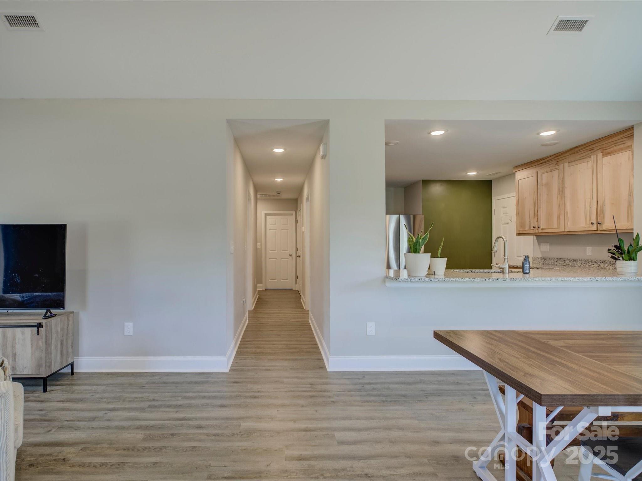 1454 King Road York, SC 29745 - Photo 6 of 34 a kitchen with granite countertop a stove top oven a sink dishwasher a dining table and chairs with wooden floor