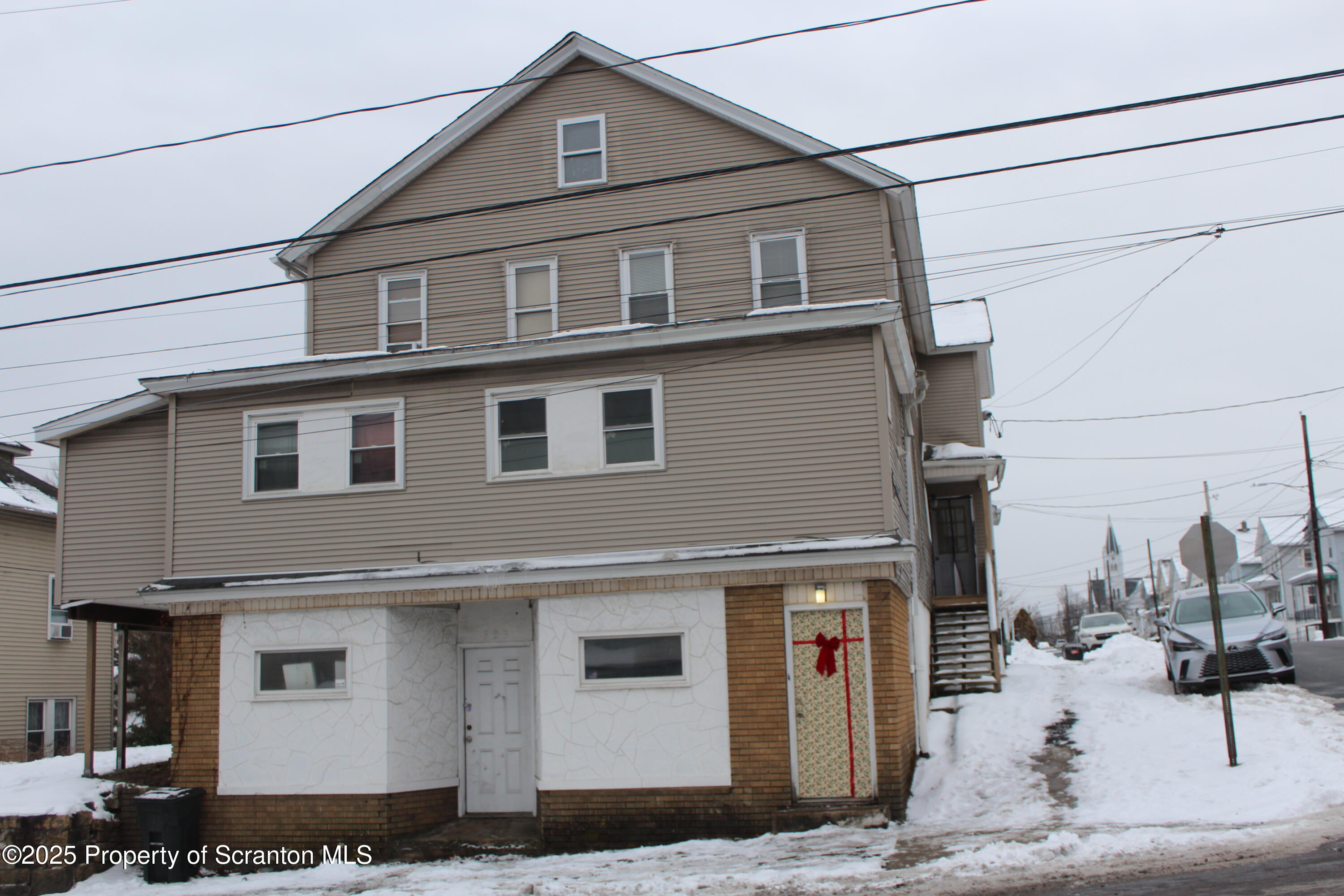 323 Union Street, Unit 1 Taylor, PA 18517 - Photo 1 of 20 a front view of a house with garage