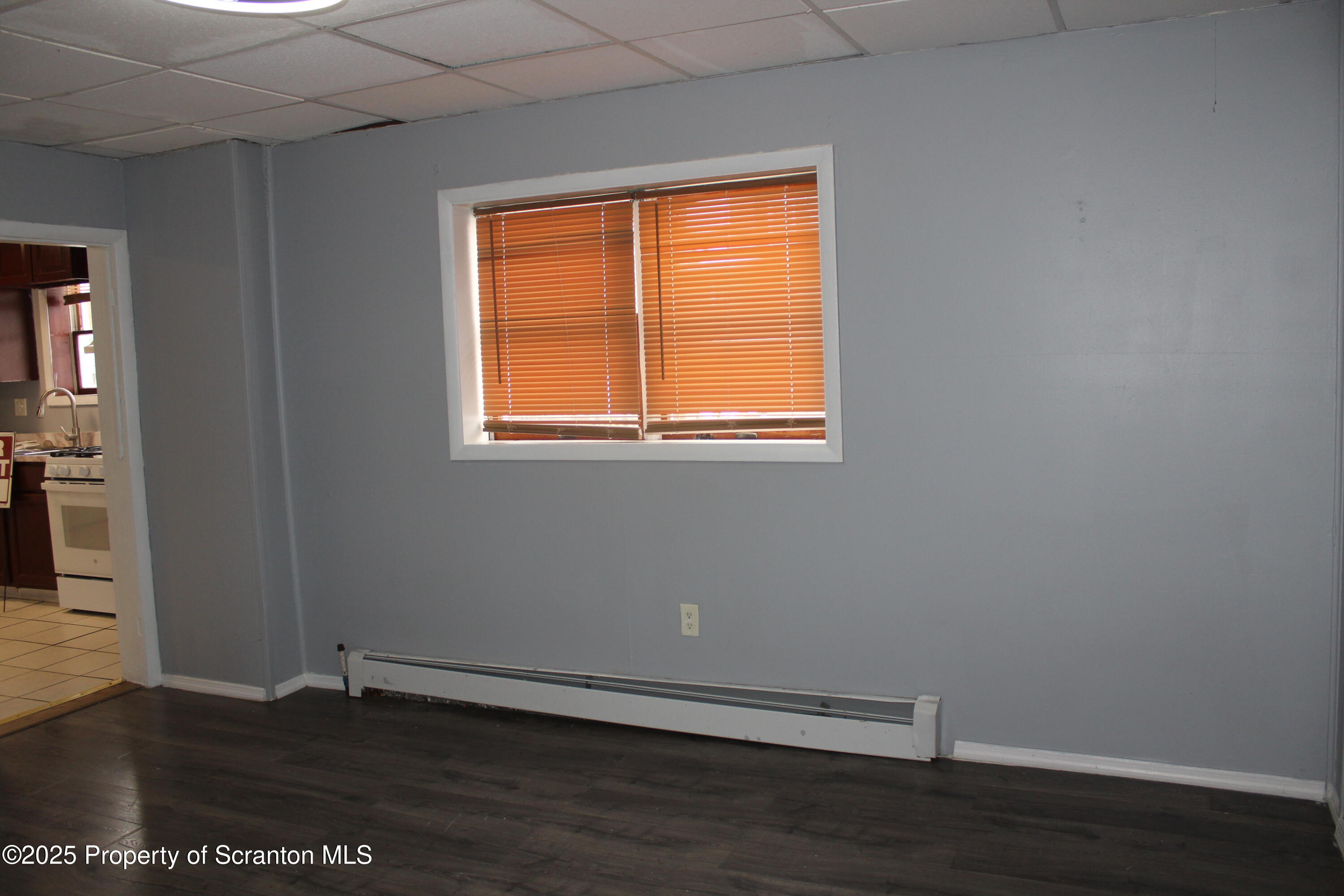 323 Union Street, Unit 1 Taylor, PA 18517 - Photo 11 of 20 an empty room with wooden floor and a window
