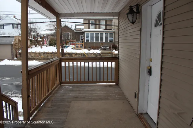 a view of a porch with wooden fence