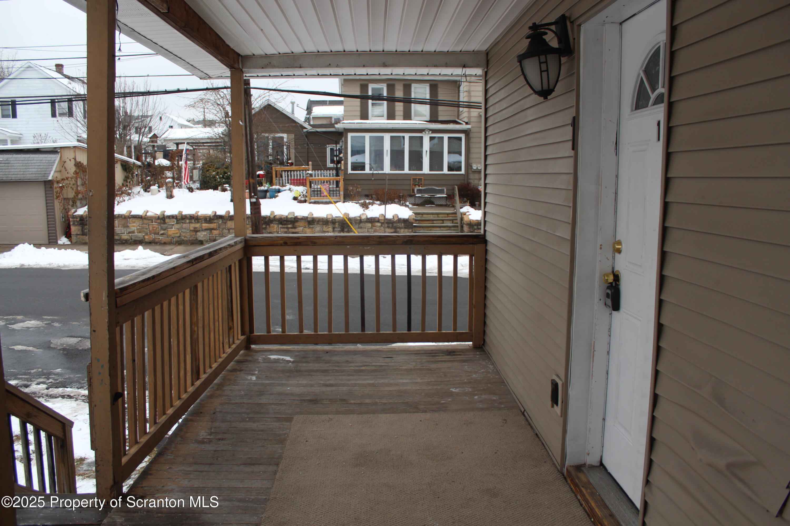 323 Union Street, Unit 1 Taylor, PA 18517 - Photo 3 of 20 a view of a porch with wooden fence