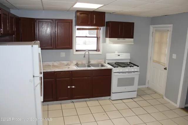a kitchen with a sink and a stove top oven