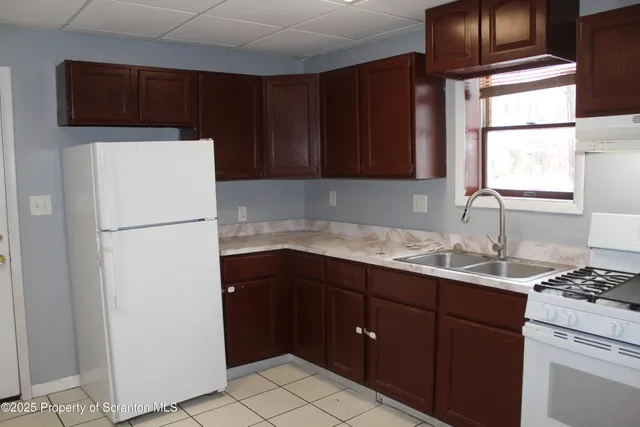 a kitchen with a refrigerator and a sink
