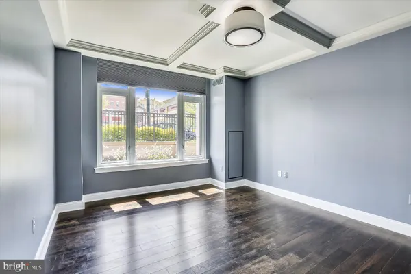 a view of an empty room with wooden floor
