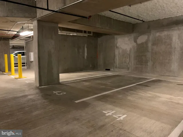 a view of a patio with table and chairs under an umbrella with wooden fence