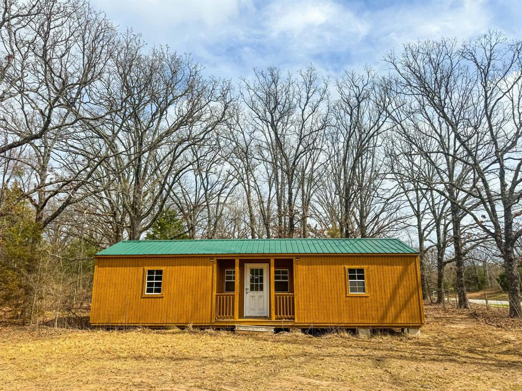 9696 Fm-515 Alba, TX 75410 - Photo 2 of 26 a backyard of a house with large trees and wooden fence