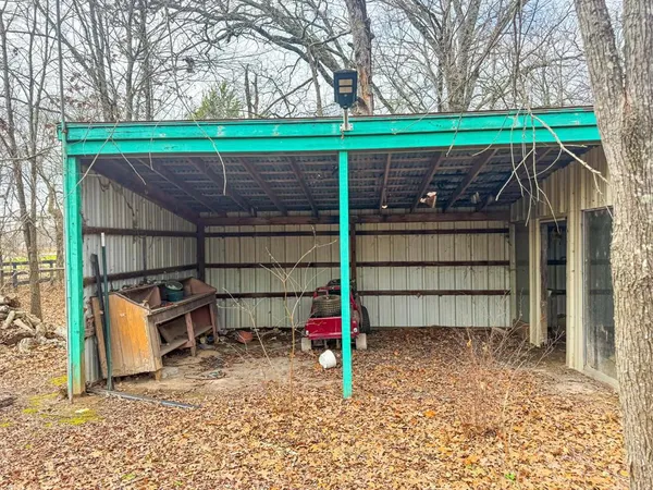 a view of a backyard with a small cabin and a chair