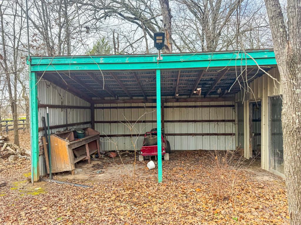 9696 Fm-515 Alba, TX 75410 - Photo 10 of 26 a view of a backyard with a small cabin and a chair