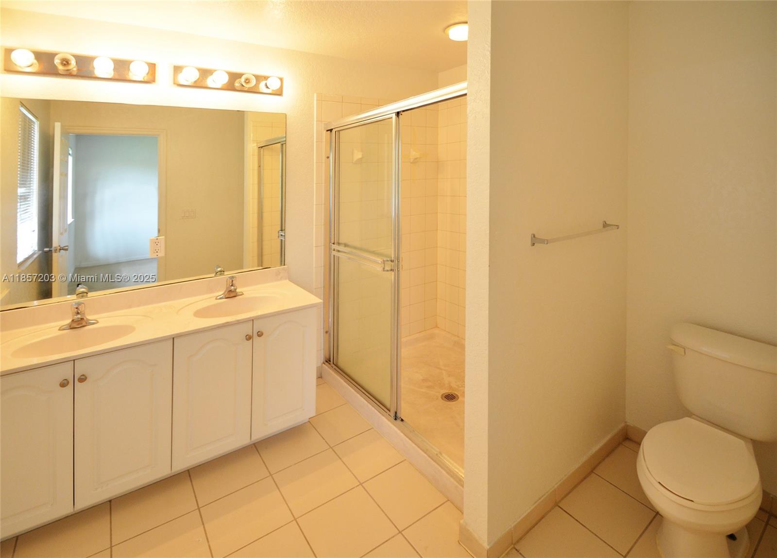 1958 Southwest 60th Terrace, Unit 1958 North Lauderdale, FL 33068 - Photo 12 of 24 a bathroom with a granite countertop sink mirror vanity and toilet