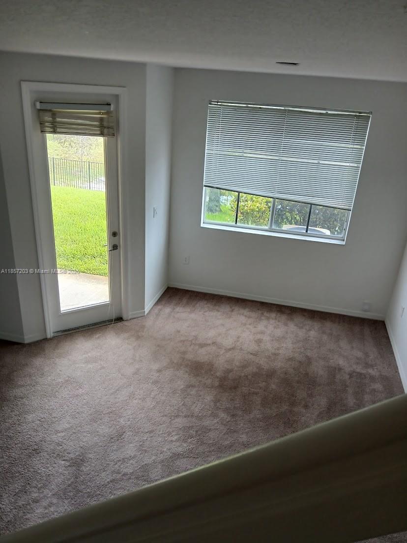1958 Southwest 60th Terrace, Unit 1958 North Lauderdale, FL 33068 - Photo 22 of 24 an empty room with a window