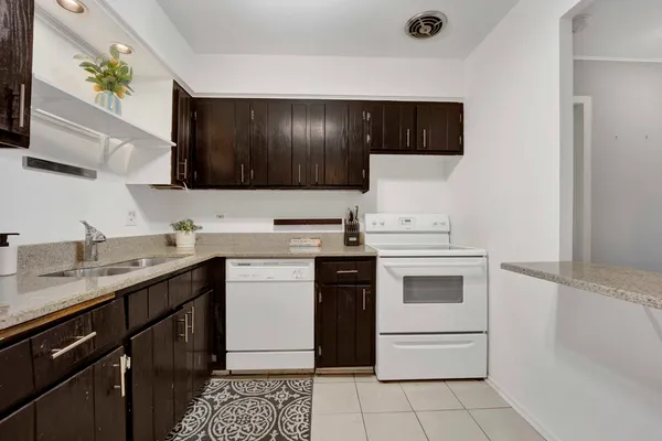 a kitchen with a sink stove and microwave