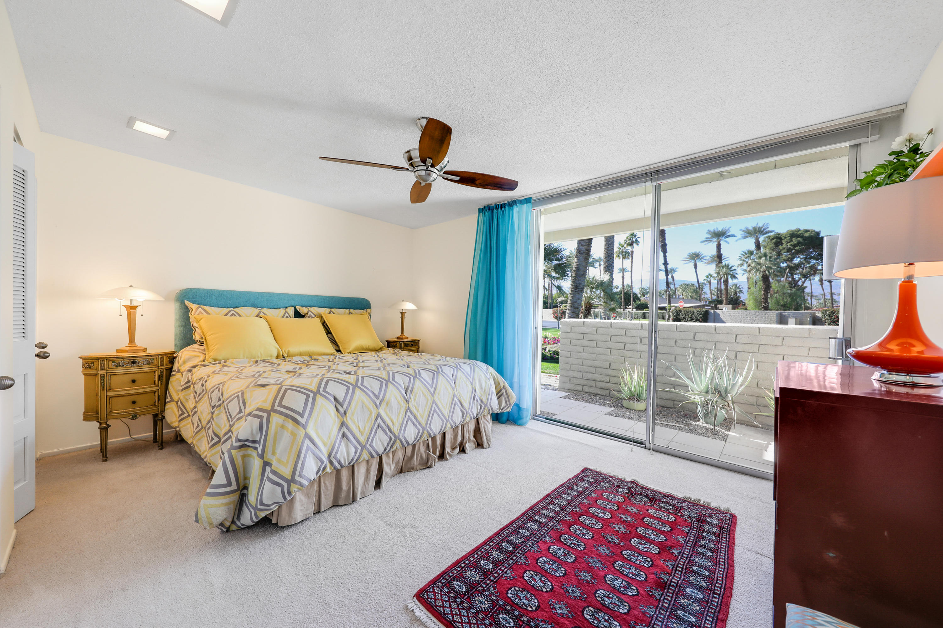 45204 Ave Codorniz Indian Wells, CA 92210 - Photo 17 of 36 a bedroom with a large bed and a chandelier