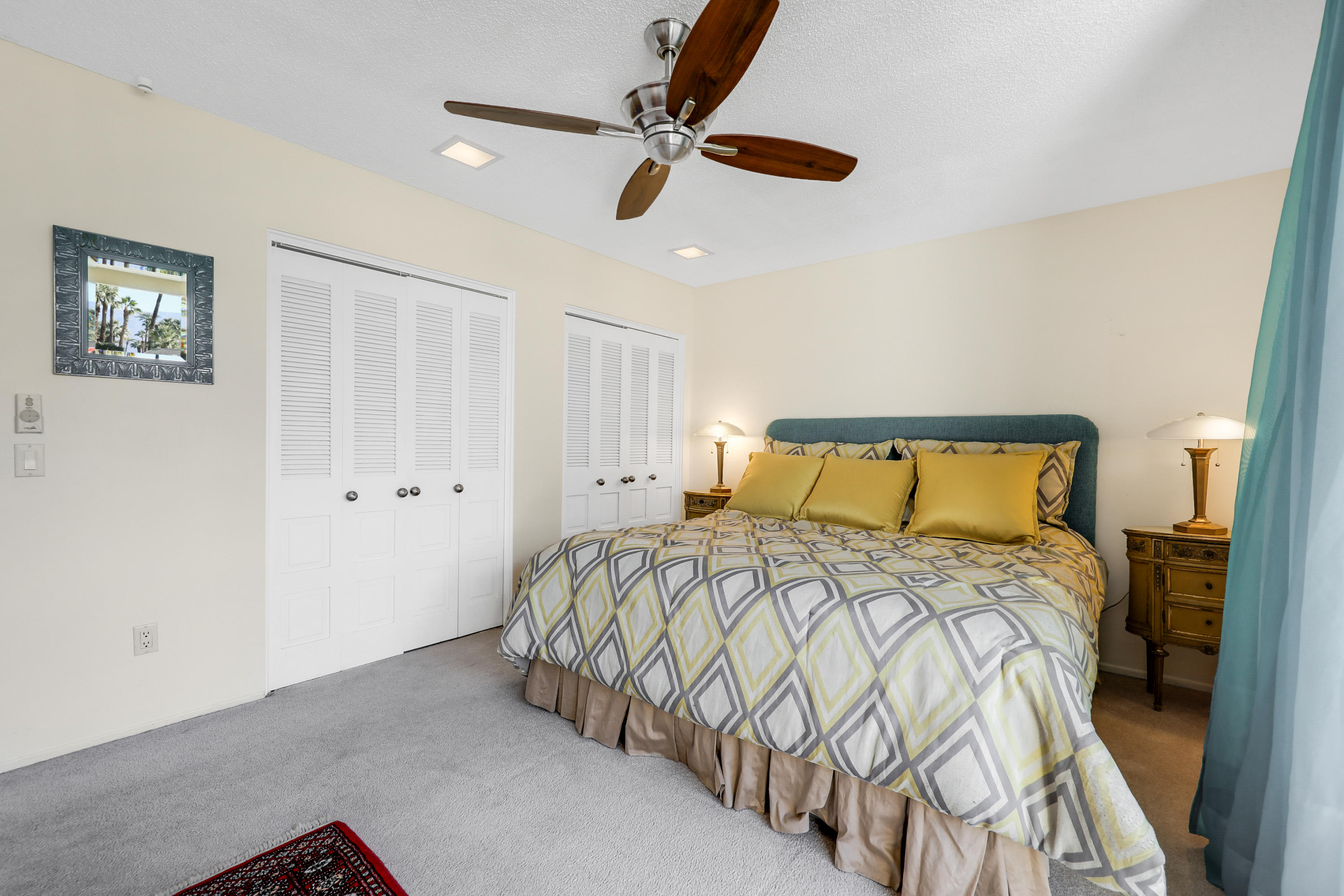 45204 Ave Codorniz Indian Wells, CA 92210 - Photo 19 of 36 a bedroom with a bed and a chandelier