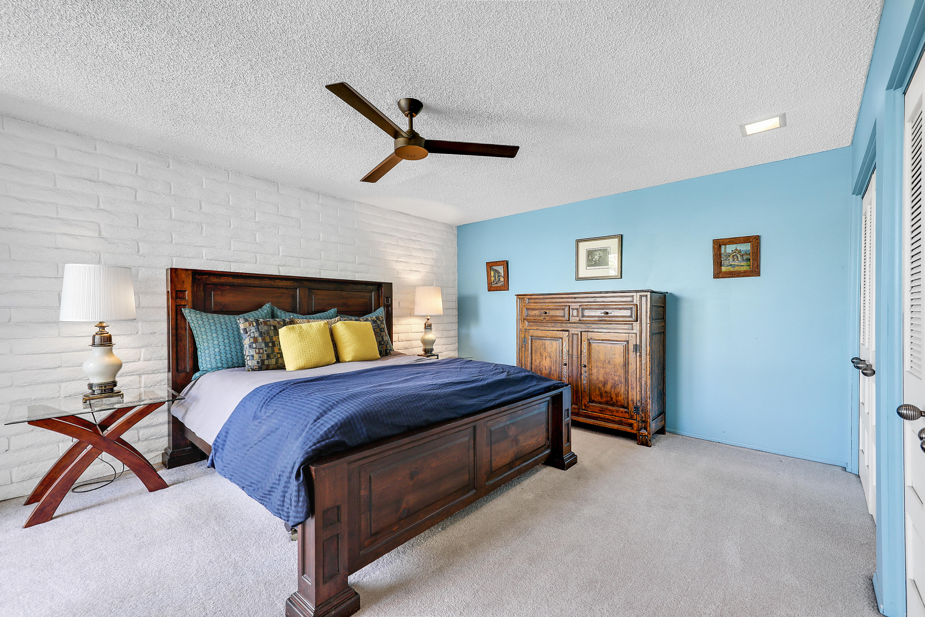 45204 Ave Codorniz Indian Wells, CA 92210 - Photo 21 of 36 a bedroom with a bed and a chandelier