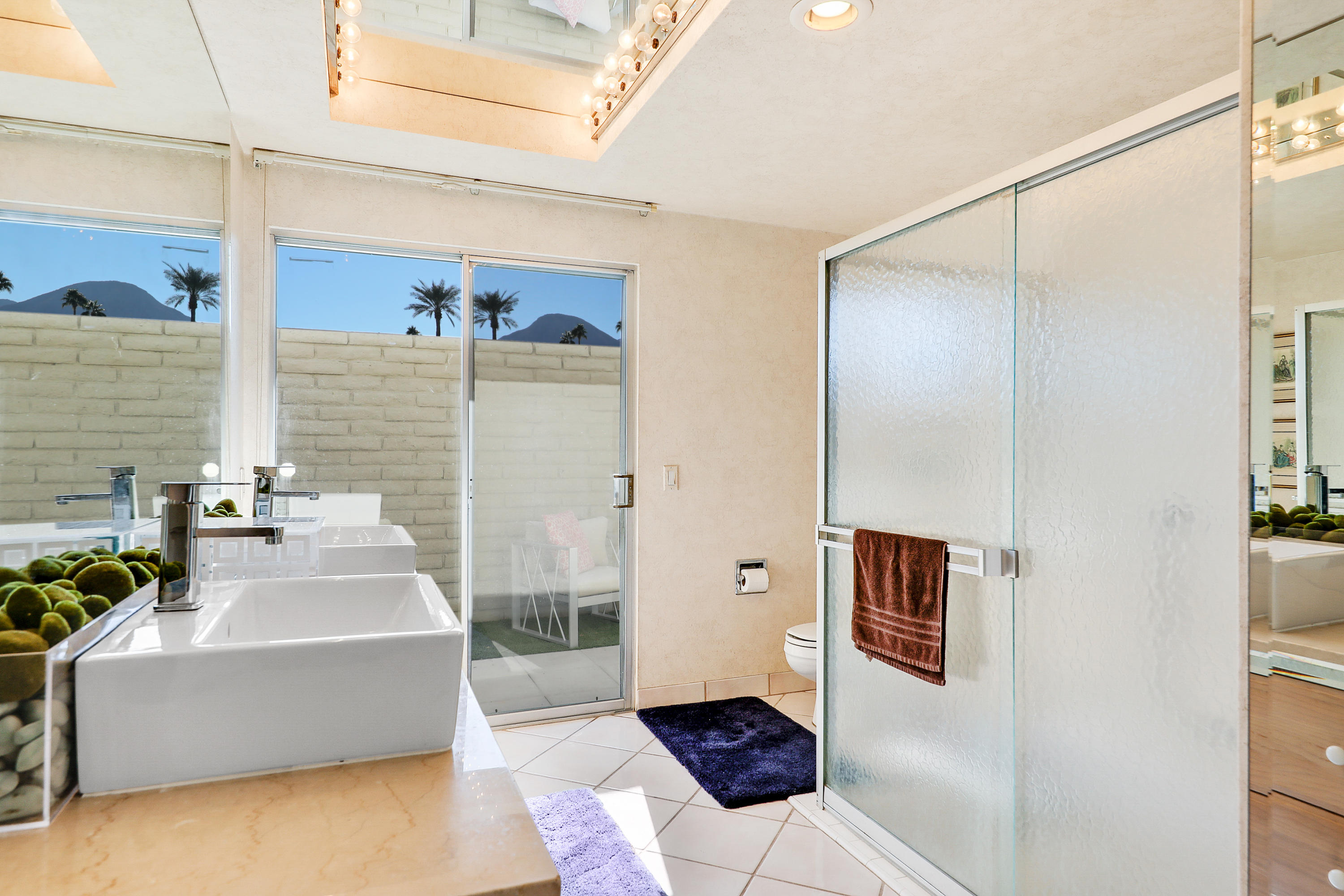 45204 Ave Codorniz Indian Wells, CA 92210 - Photo 24 of 36 a bathroom with a tub shower and sink