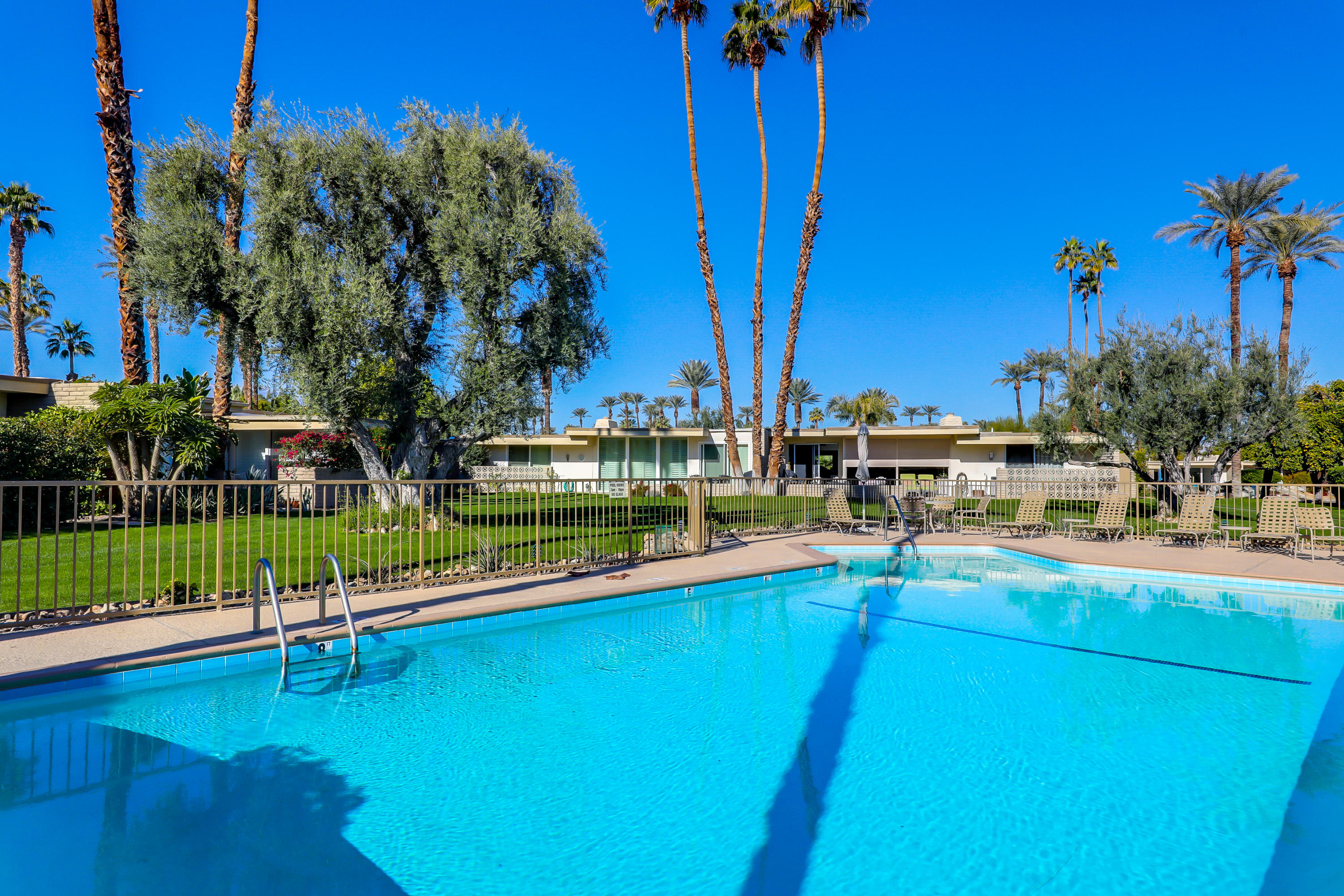 45204 Ave Codorniz Indian Wells, CA 92210 - Photo 30 of 36 a view of a swimming pool with a bench and lawn chairs