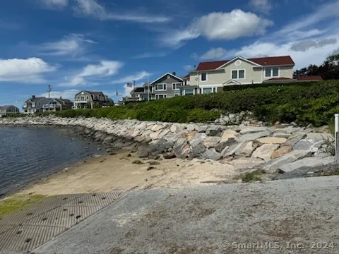a view of a dirt road with a building in the background