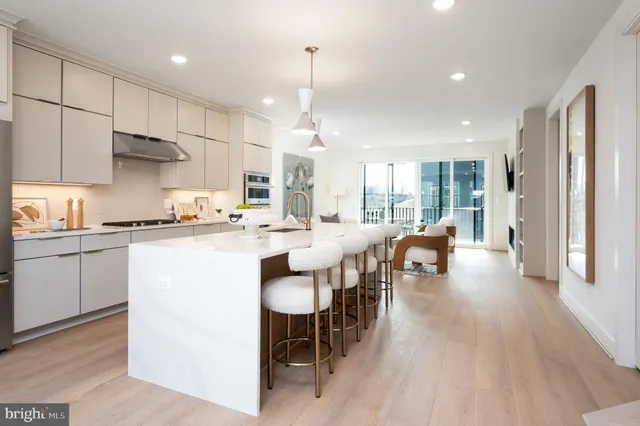 a kitchen with counter space dining table and stainless steel appliances
