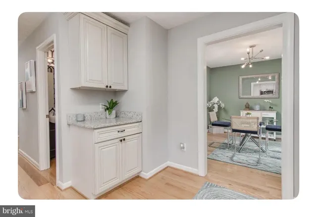 a hallway with cabinets and outdoor view